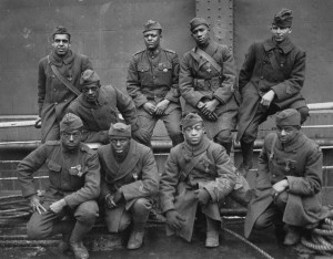 B&W photo of a dozen black men in WW1 uniforms