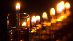 Hanukkah candles lit in a diagonal row.
