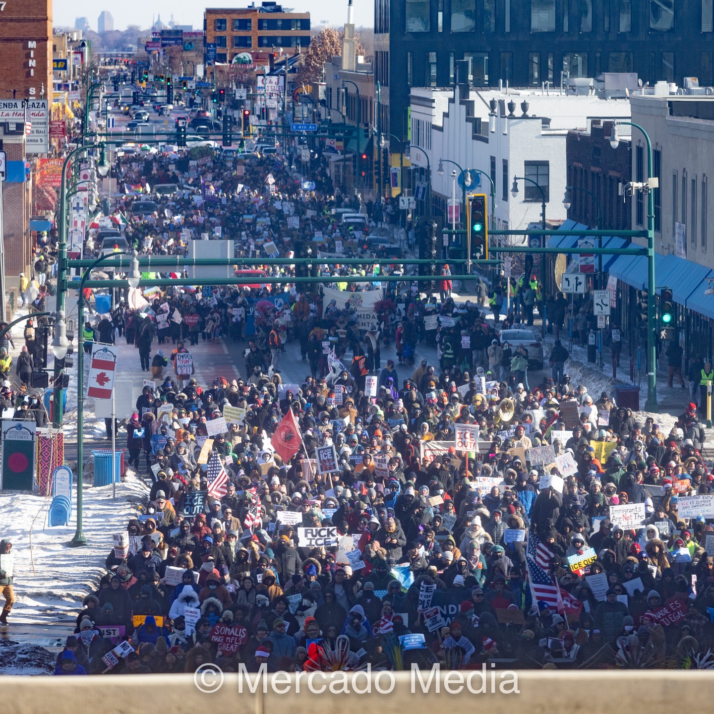 A long aerial shot of 10,000+ people marching down a wintry Lake Street in Minneapolis.